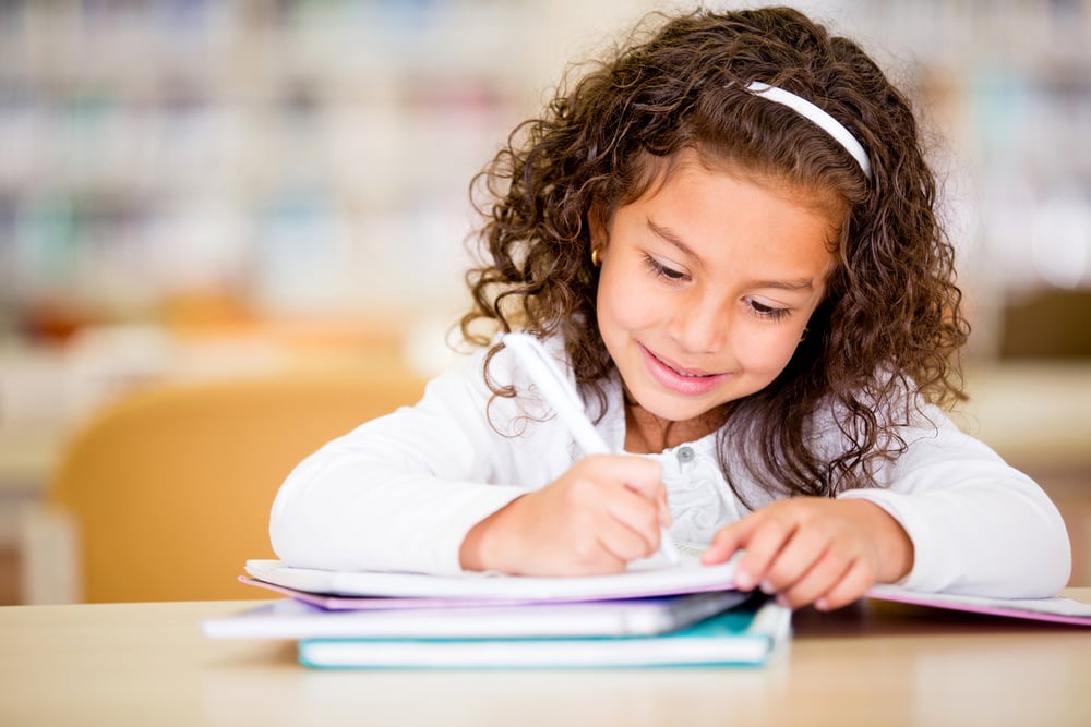 Girl studying at school looking very happy Girl studying at school looking very happy
